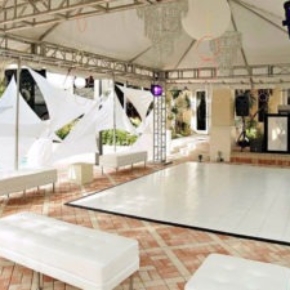 A slate white dance floor looks elegant in this airy event space.