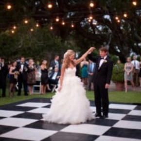 A classic checkered slate look dance floor complements this outdoor wedding.
