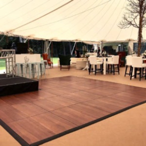 Dark Maple Plus dance floor with edges at a tent event