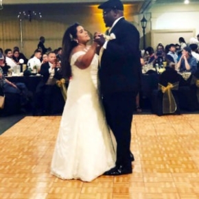 Couple dances at wedding on an Oak style dance floor
