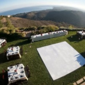Aerial view of ocean wedding with slate white portable dance floor