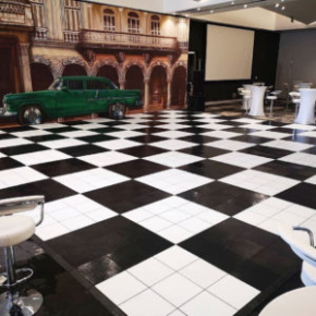 Large slate black and white checkered dance floor at event