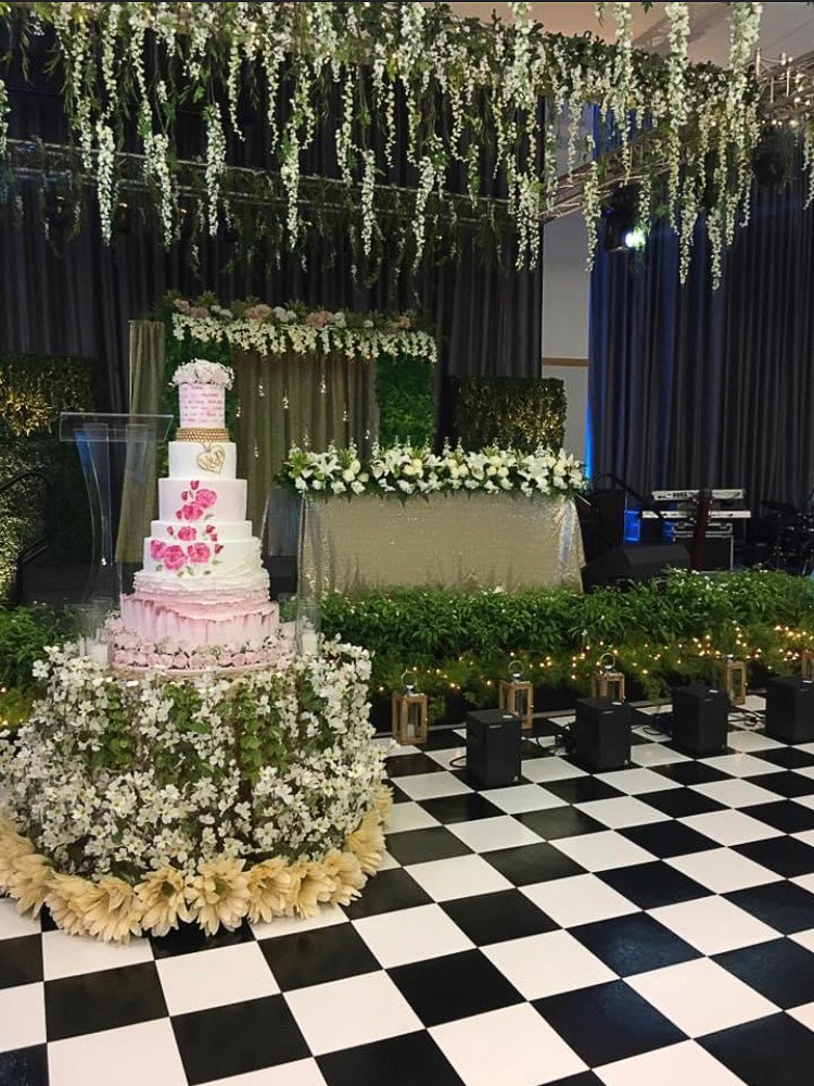 Wedding cake on checkered slate black and white dance floor