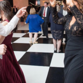 Guests dancing on a SnapLock Plus slate white and black checkered dance floor