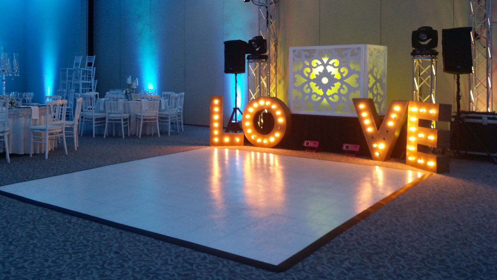 12 By 12 slate white dance floor with edging, Love sign with lights in event space