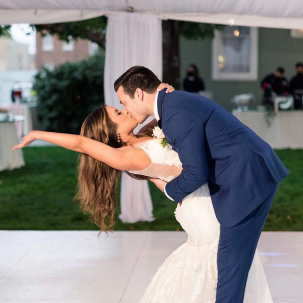 Couple kisses dancing on Slate White style wedding dance floor