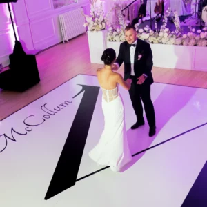 Bride and groom dance on a slate white dance floor