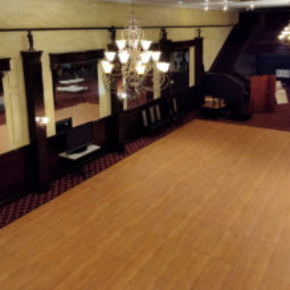 Maple plus rectangular dance floor under chandeliers