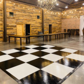 Slate black and white plus style dance floor in barn with chandelier