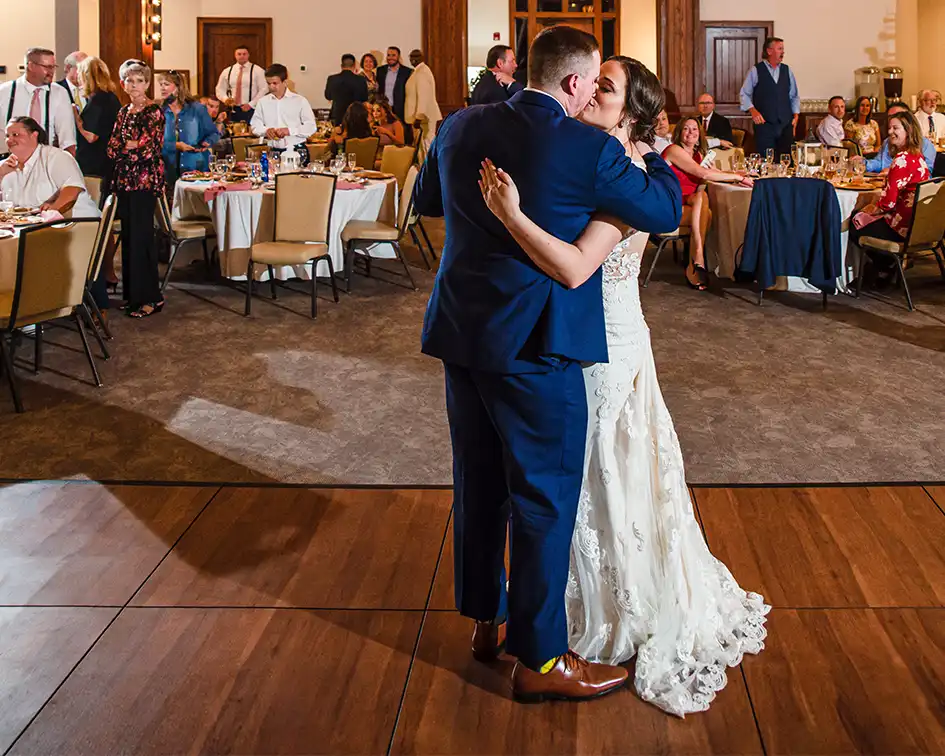 A husband and wife take their first dance on a dark-maple dance floor from SnapLock Dance Floors.